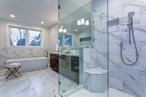 Incredible master bathroom with Carrara marble tile surround.